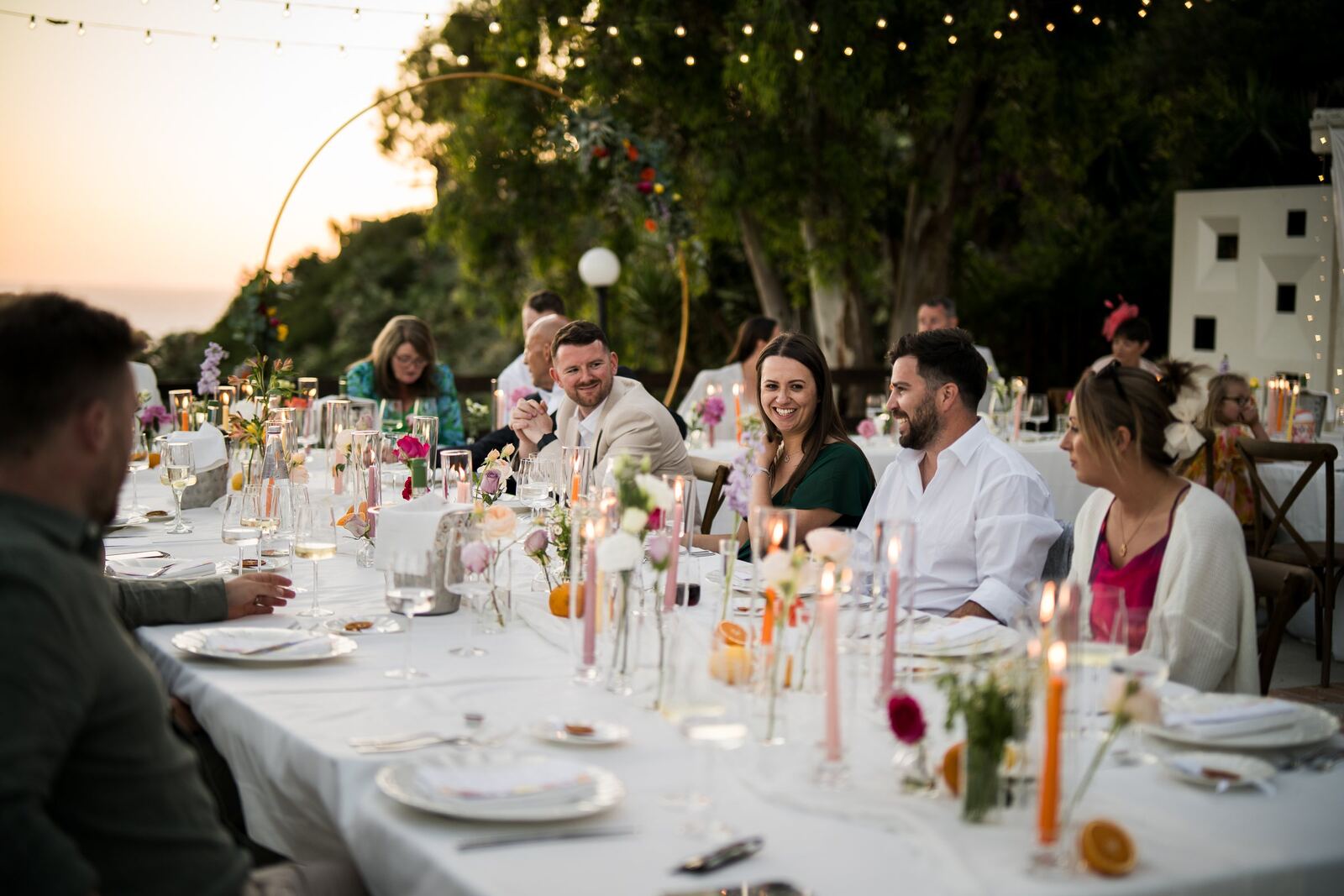 Guests at a candlelit dinner on the terrace