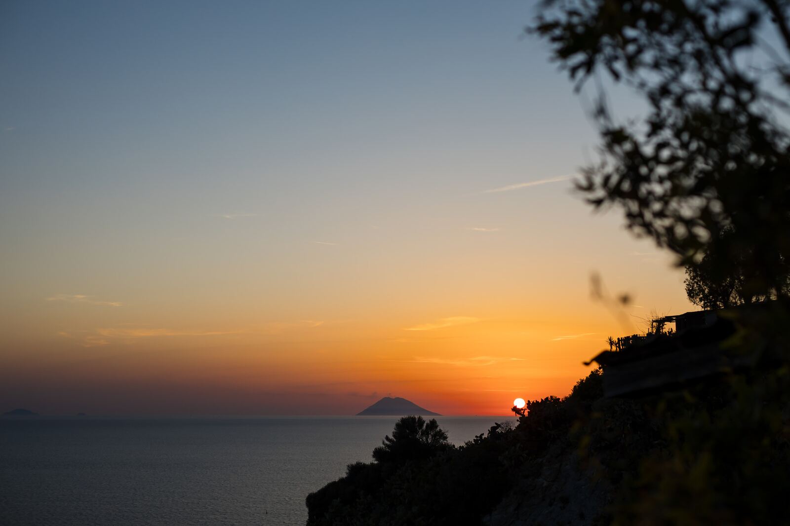 Sunset from the terrace with an island silhouetted on the horizon